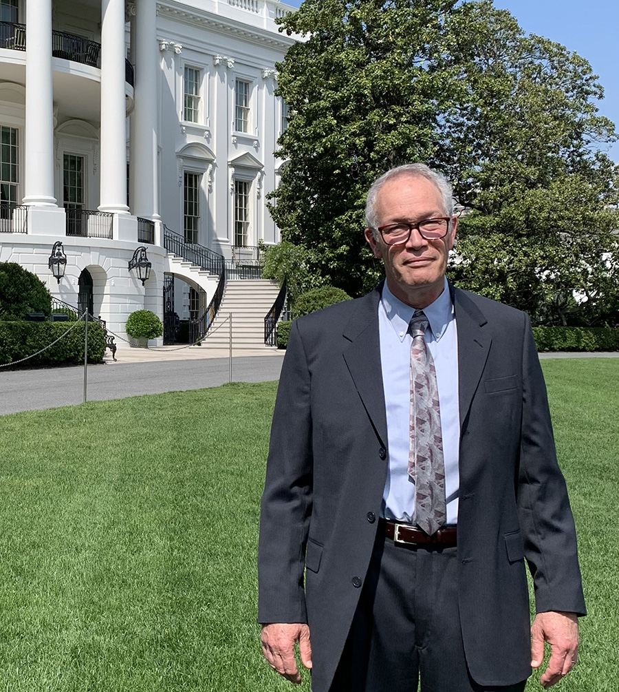 Tom Quinn standing in front of the White House